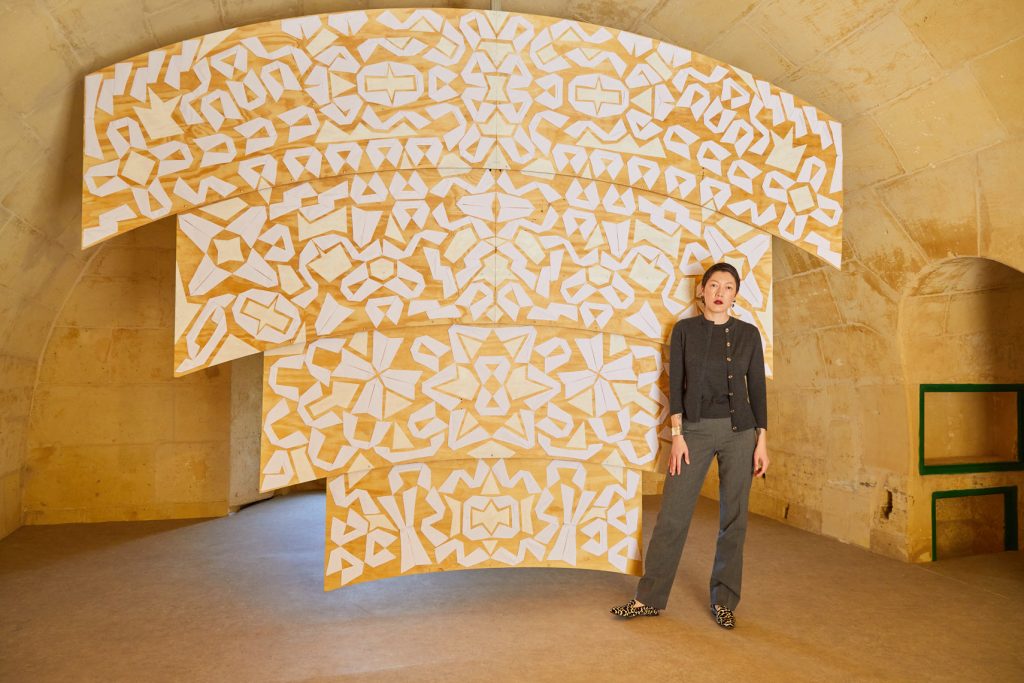 Aziza Shaden presents a site-specific hanging sculpture composed of white cotton collars produced in Uzbekistan.